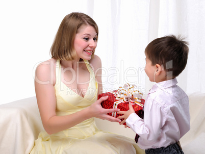 Mom giving a gift to his son