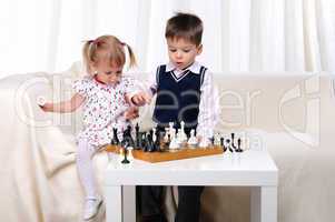 Brother and sister playing chess