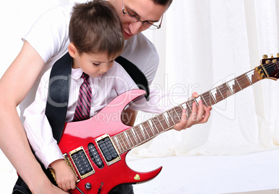 young father teaches his young son
