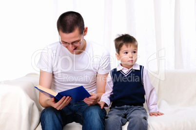 Father and son reading a book