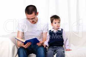 Father and son reading a book