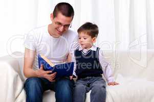 Father and son reading a book