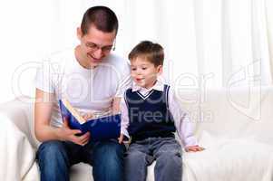 Father and son reading a book