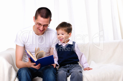 Father and son reading a book