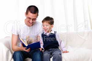 Father and son reading a book