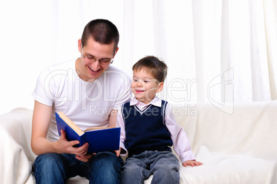 Father and son reading a book