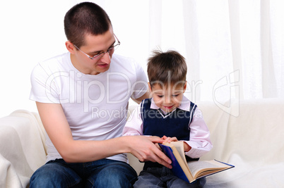 Father and son reading a book