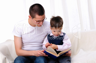 Father and son reading a book