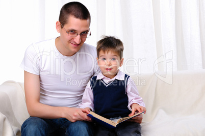 Father and son reading a book