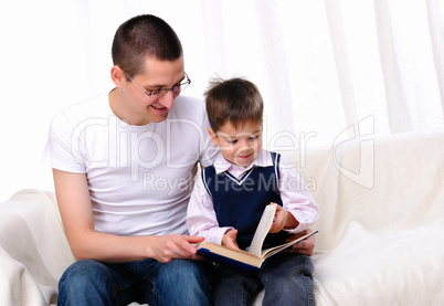 Father and son reading a book