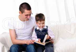 Father and son reading a book