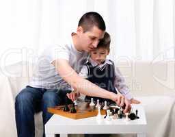 Dad and son playing chess