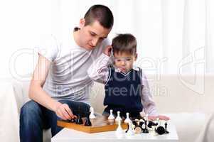 Dad and son playing chess