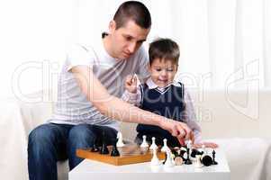 Dad and son playing chess