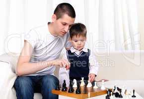 Dad and son playing chess