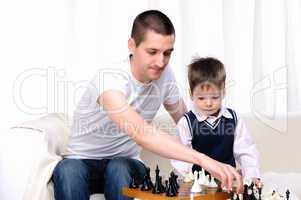 Dad and son playing chess