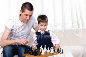 Dad and son playing chess