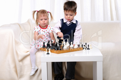 Brother and sister playing chess