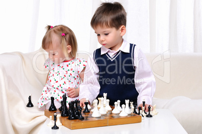 Brother and sister playing chess