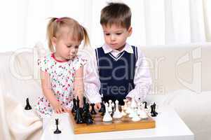 Brother and sister playing chess