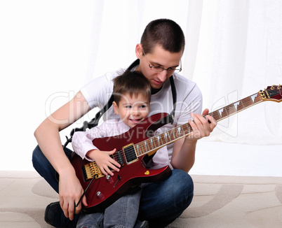 young father teaches his young son