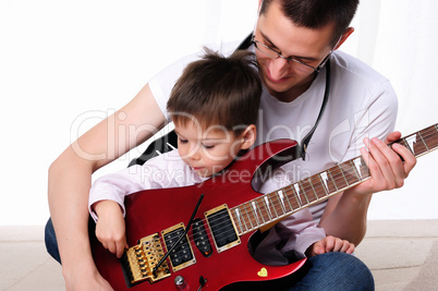 young father teaches his young son