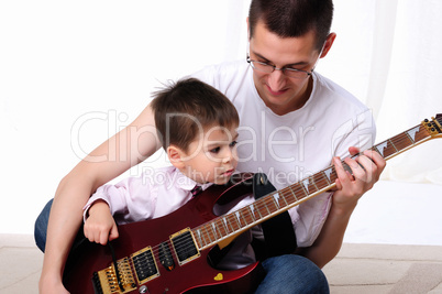 young father teaches his young son young father teaches his young son