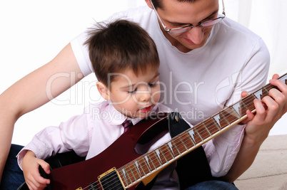 young father teaches his young son