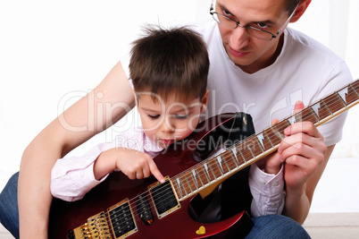 young father teaches his young son