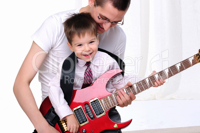 young father teaches his young son