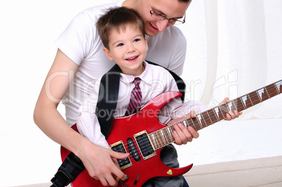 young father teaches his young son