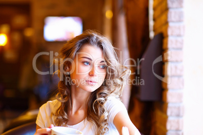 Young pretty woman sitting in restaurant