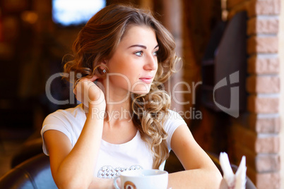 Young pretty woman sitting in restaurant