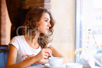 Young pretty woman sitting in restaurant