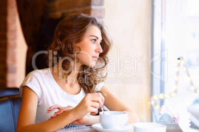 Young pretty woman sitting in restaurant