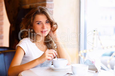 Young pretty woman sitting in restaurant