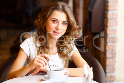 Young pretty woman sitting in restaurant