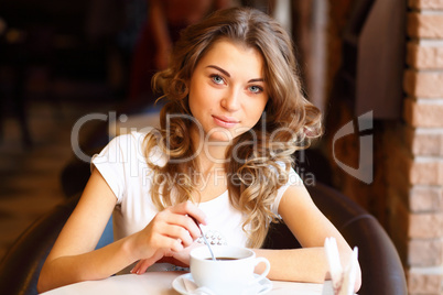 Young pretty woman sitting in restaurant