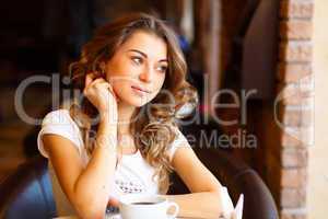 Young pretty woman sitting in restaurant