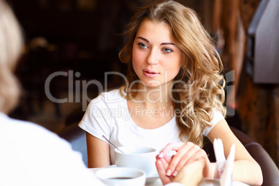 Young pretty woman sitting in restaurant