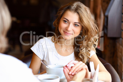 Young pretty woman sitting in restaurant