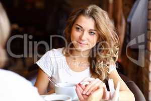 Young pretty woman sitting in restaurant