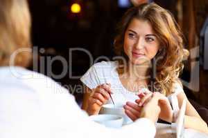 Young pretty woman sitting in restaurant