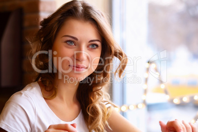 Young pretty woman sitting in restaurant