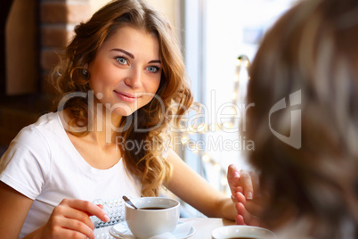 Young pretty woman sitting in restaurant