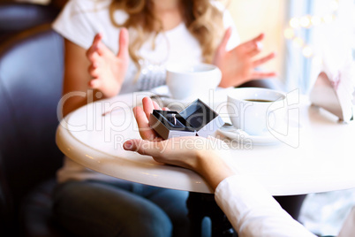 Young couple with engagement ring in a restaurant