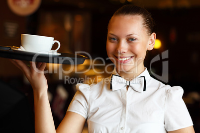 Portrait of young waitress holding a tray
