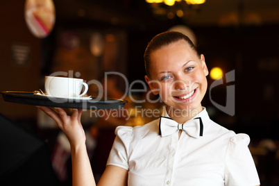 Portrait of young waitress holding a tray