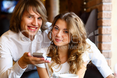 Young couple with engagement ring in a restaurant