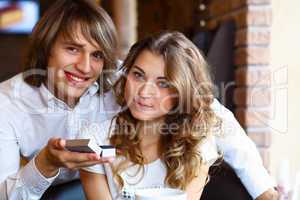 Young couple with engagement ring in a restaurant